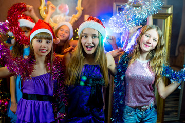 Group of cheerful young girls celebrating Christmas