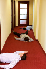 Three businessman lying down in office