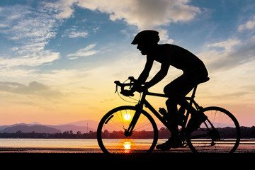 Man cycling at the beach twilight time