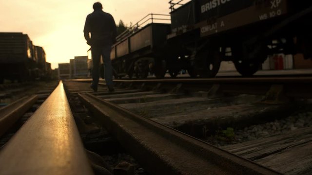 lonely sad man on the railway: sunset goodbye