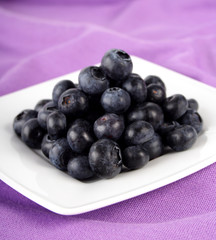 Blueberries on white plate - close up