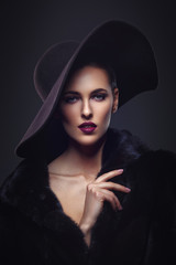 Beautiful girl in fur coat and hat