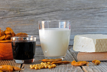 Soybean milk, sauce and tofu on a wooden table