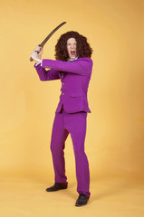 Caucasian man with afro wearing Purple Suit carrying sword