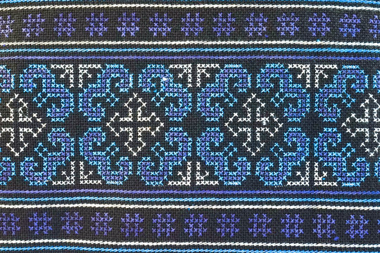Ethnic pattern. Classic pattern from hill tribe embroidery. pattern in native hill tribe style in aquatic blue on coin purse or smartphone purse, popular souvenir texture surface