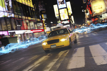 Taxi on city street at night