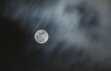 Naklejka na ściany i meble Bright full moon with blurry moving cloud of night sky