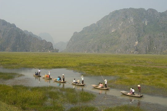 Punting boats on delta river, limestone mountain scenery, Van Long, Ninh Binh, south of Hanoi, North Vietnam