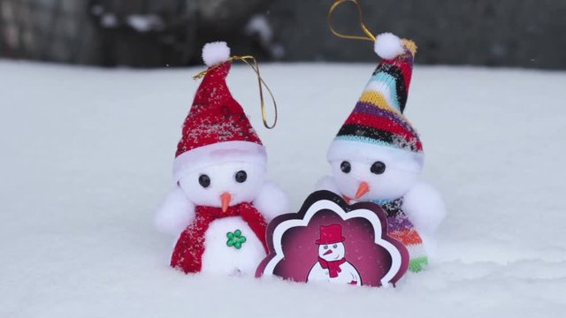 Three snowmen in snow