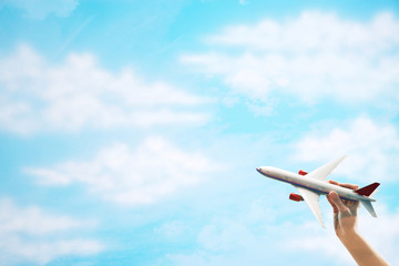 Toy Plane flying against clouds