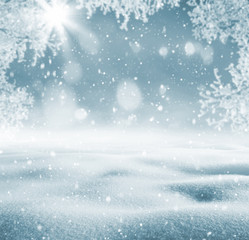 Winter background. Winter bright landscape with snowdrifts and falling snow. Branches of trees in hoarfrost.