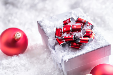 Christmas gift box with christmas balls in abstract snowy scene.