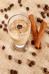 coffee cream liqueur in a glass  with coffee beans and cinnamon