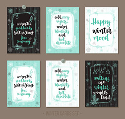Set winter and holidays greeting cards with handwritten brush calligraphy and decorative elements.