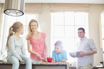 Family preparing food in kitchen