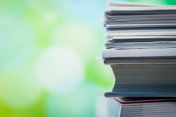 Stacks of Papers Against Green Background