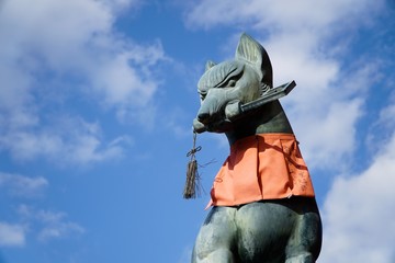 KYOTO, JAPAN - NOVEMBER 22 2016 : Fushimi inari stone fox guarda . Foxes are believed to be messengers of god.