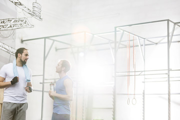 Men conversing in crossfit gym