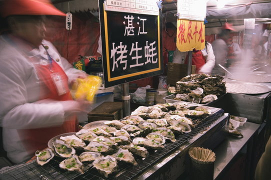 Street market selling oysters in Wanfujing shopping street, Beijing, China
