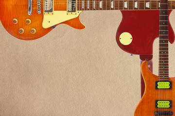 Mahogany and sunburst electric guitars and and back of guitar body on the rough cardboard...