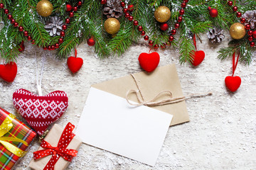 Fototapeta na wymiar christmas greeting card with envelope on white wooden background
