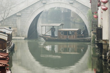 Traditional stone arched bridge and river boat in Shantang water town, Suzhou, Jiangsu Province, China