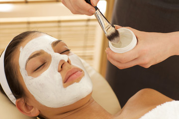 Close-up of young woman with facial mask