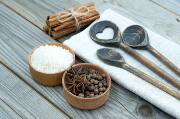 wooden spoons and set of spices on wood background