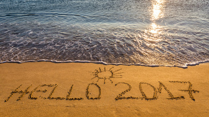 Fototapeta premium Hello New Year 2017 concept, lettering on the beach