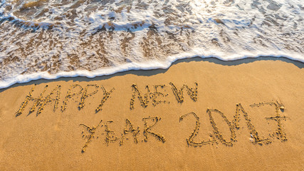 Happy New Year 2017 concept, lettering on the beach