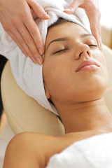 Young woman receiving energy therapy, eyes closed