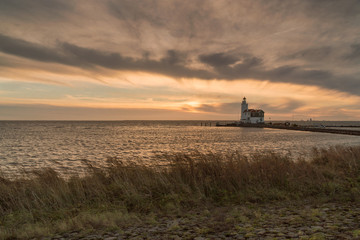 Fototapeta premium The lighthouse of Marken at sunrise in winter