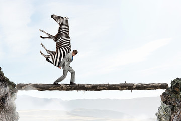 Businessman carrying zebra . Mixed media