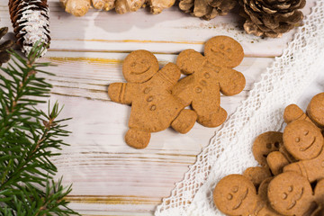 Many Christmas smiling  gingerbread men on white lace