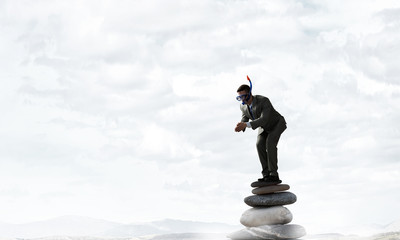 Businessman diving from top . Mixed media