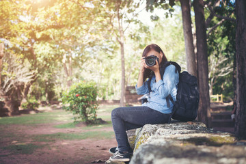 Fototapeta premium Young attractive woman photographer tourist with backpack.