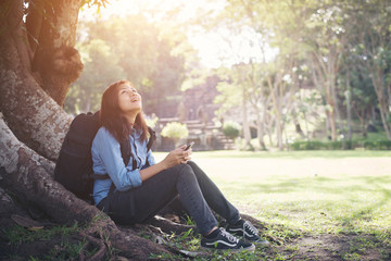 Young hipster woman typing on her phone.