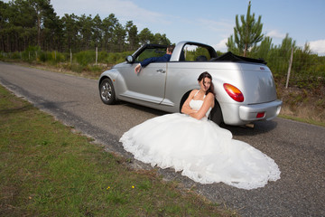 sad woman during wedding day in front of marriage car