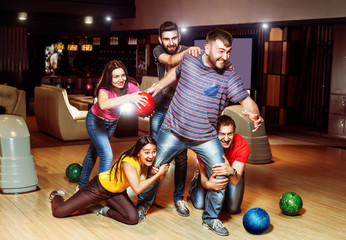 Fototapeta na wymiar Friends having fun in bowling