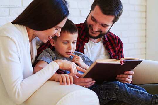 Lovely parents share special time with child while reading an in