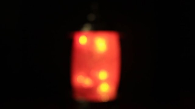 Unfocused orange lamp in the darkess