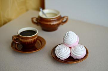 Marshmallow and cup of black coffee