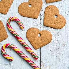 Christmas backgrounds. Christmas decor on wooden background with cookies and cane.