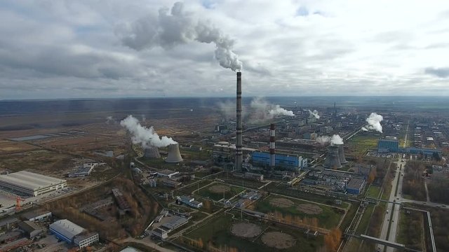 Aerial flying over dirty exhaust area. Heavy industry factories area, smoke from chimneys. 4K.