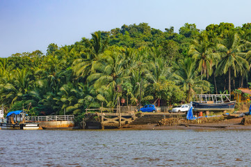 Lifestyle in Chorao island, Goa, India. Old boat for transportation to the Salim Ali Bird Sanctuary. View from the ferry arriving on the island.