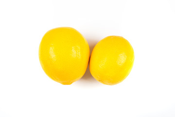 Two meyer lemons isolated on white background