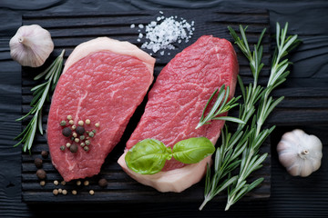 Pair of raw seasoned beef medallions, flat-lay view, close-up