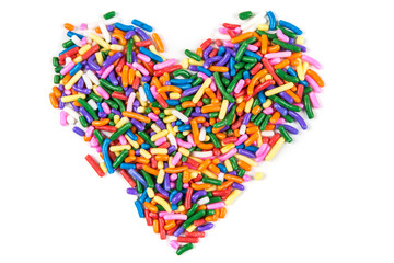 Heart shaped assorted rainbow colored sprinkles isolated on white background