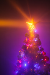 Fototapeta na wymiar Christmas tree with shining star and dense smoke