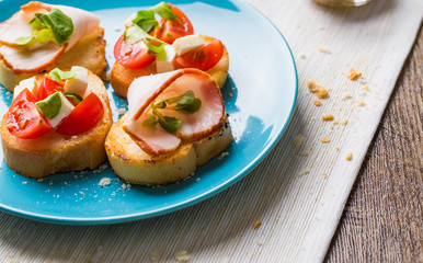 Bruschetta with tomato, cheese and bacon